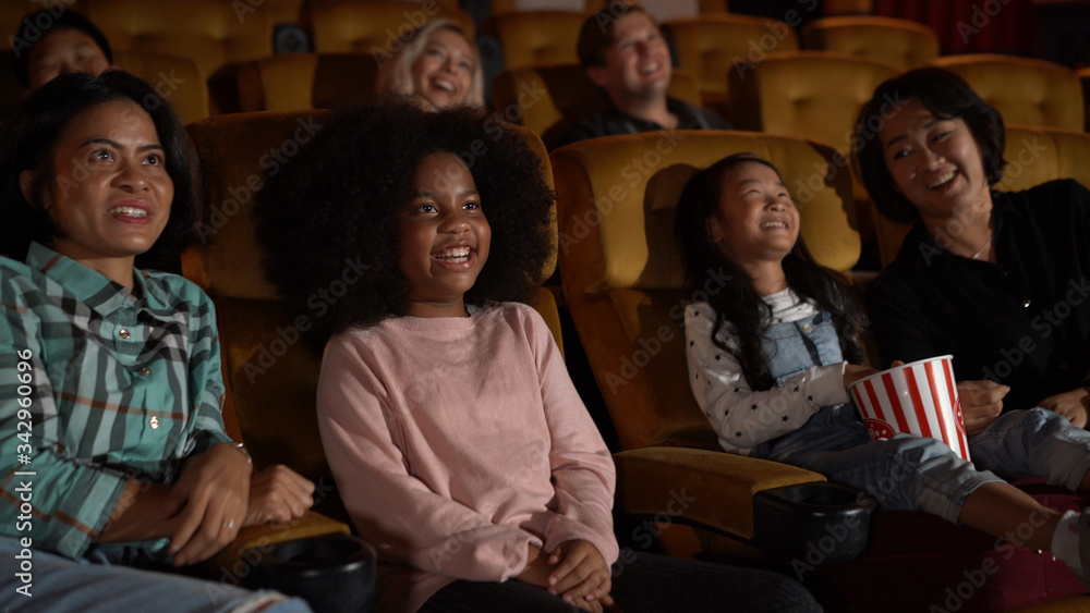 People audience watching movie in the movie theater cinema. Group recreation activity and entertainm