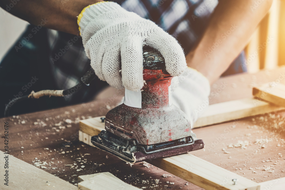 Carpenter working on wood craft at workshop to produce construction material or wooden furniture. Th