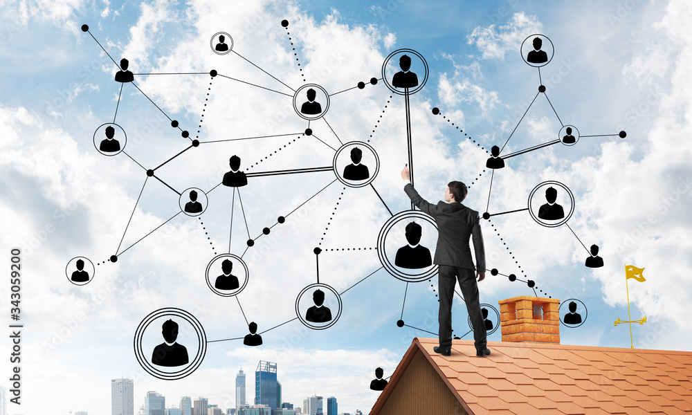 Businessman on house roof presenting networking and connection concept. Mixed media