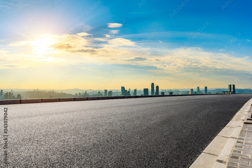 Empty asphalt road and Chongqing city skyline and buildings at sunset,China.