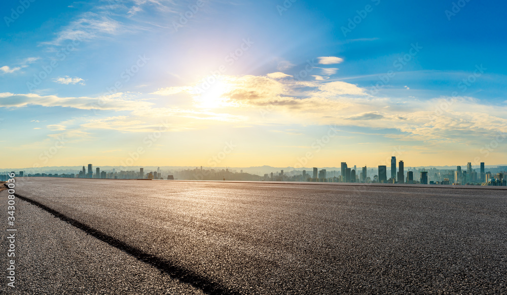 Empty asphalt road and Chongqing city skyline and buildings at sunset,China.