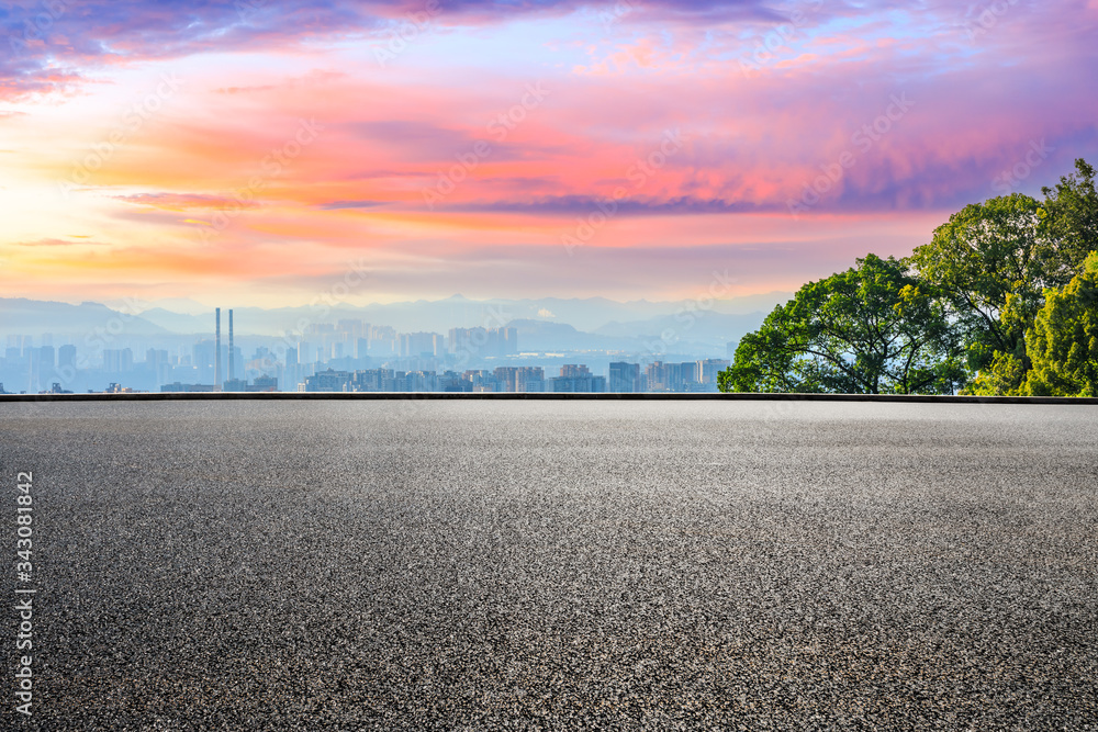 Empty asphalt road and Chongqing city skyline and buildings at sunset,China.