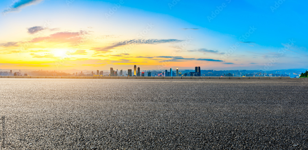 Empty asphalt road and Chongqing city skyline and buildings at sunset,China.