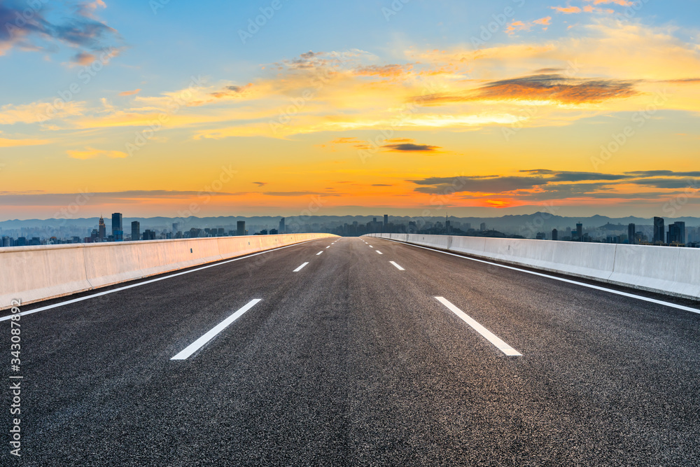 Empty asphalt road and Chongqing city skyline and buildings at sunset,China.