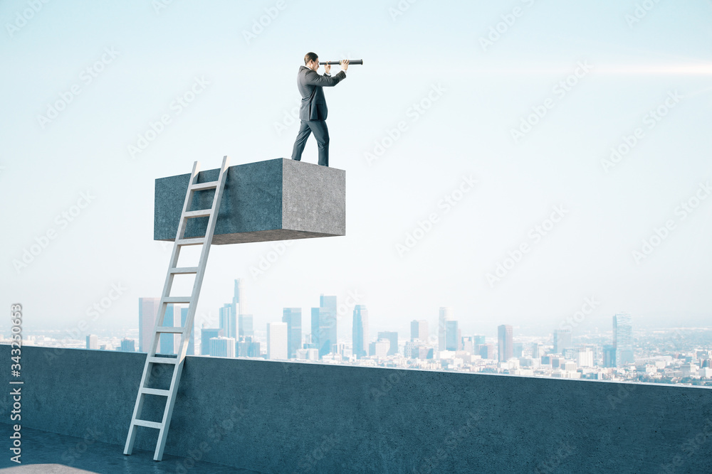 Businessman with telescope standing on concrete cube