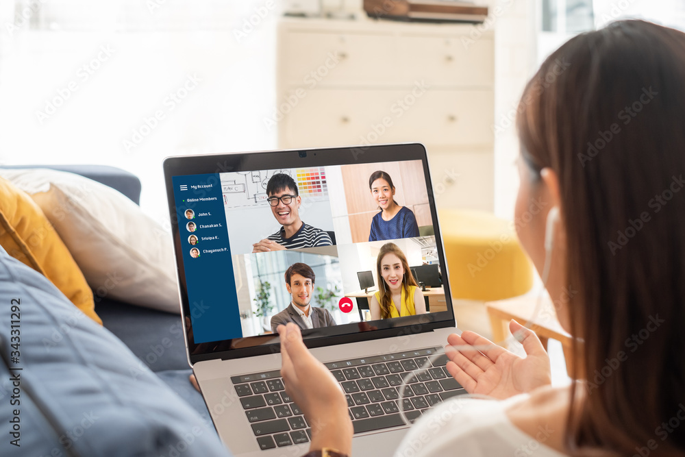 Young Asian businesswoman work at home and virtual video conference meeting with colleagues business