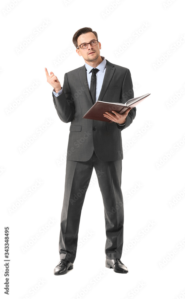 Portrait of thoughtful businessman with book on white background