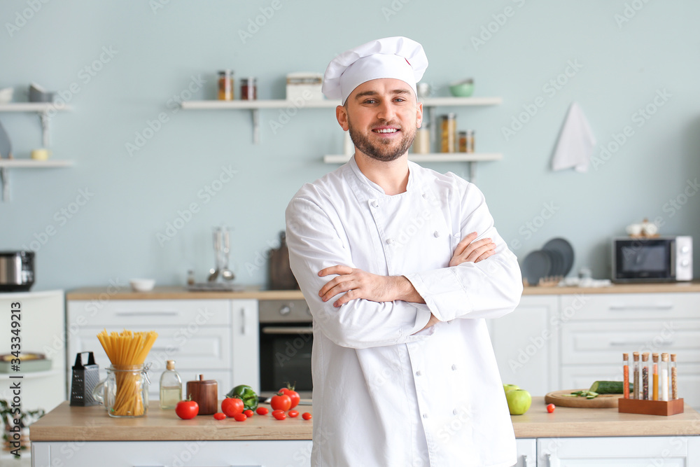 Handsome male chef in kitchen