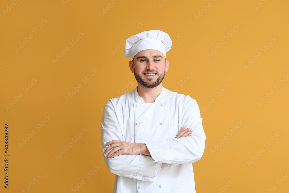 Handsome male chef on color background