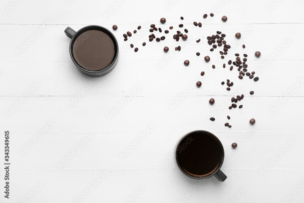 Cups of coffee on white wooden background