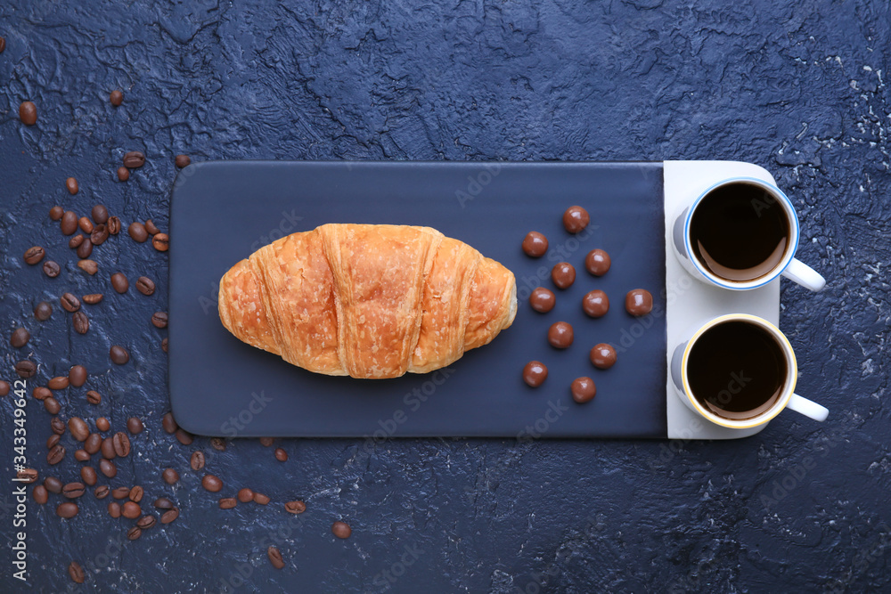 Cups of coffee with sweets on dark background