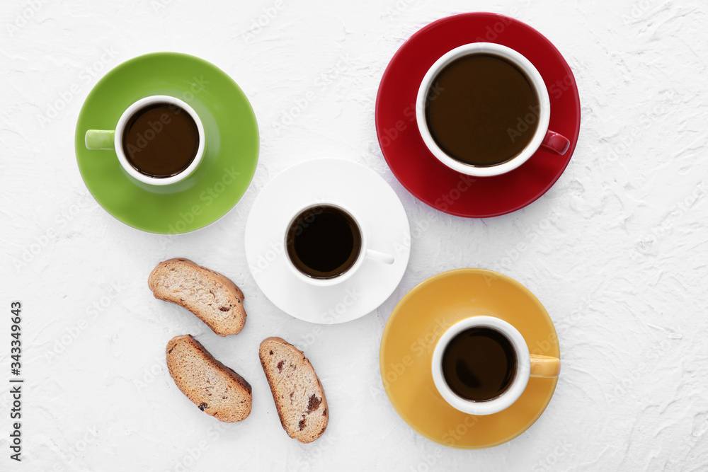 Cups of coffee with cookies on white background