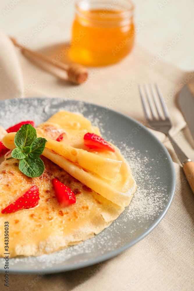 Plate with tasty blini and berries on table, closeup