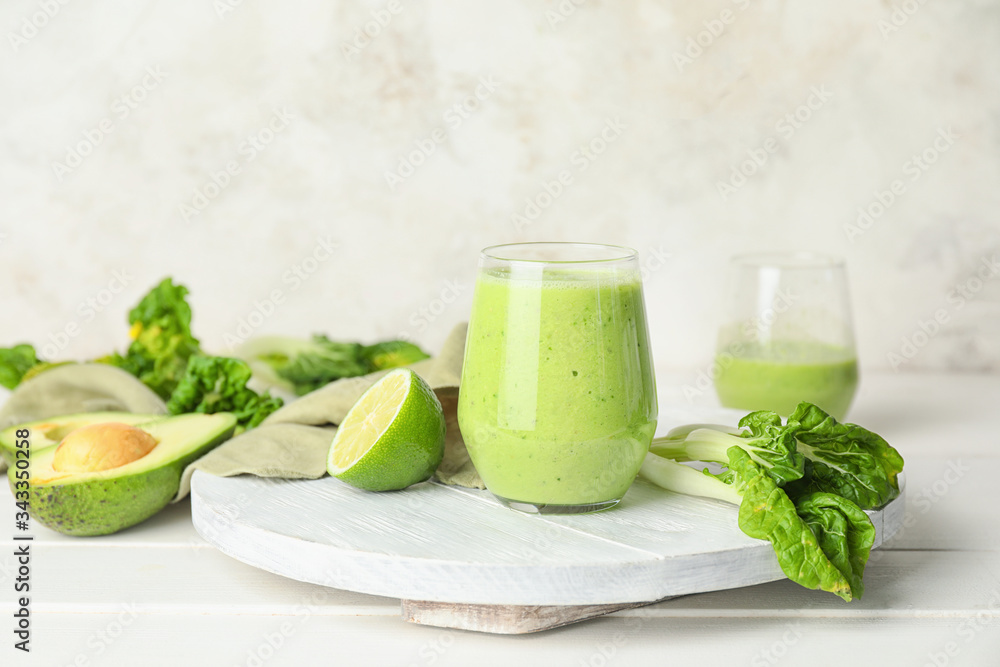 Glass of healthy smoothie and ingredients on table