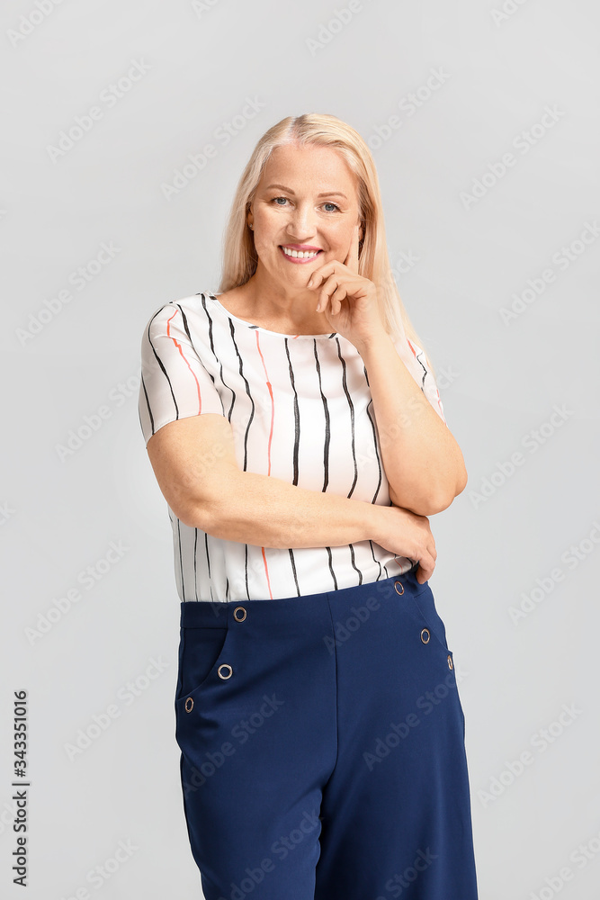 Portrait of mature businesswoman on light background