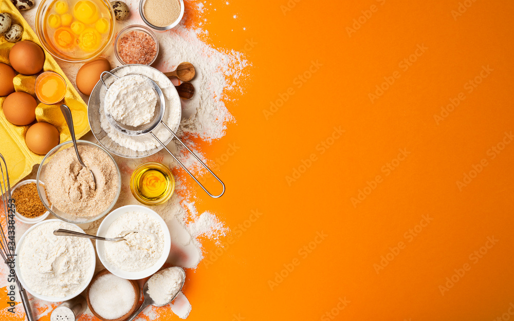 Baking ingredients on yellow color background, top view