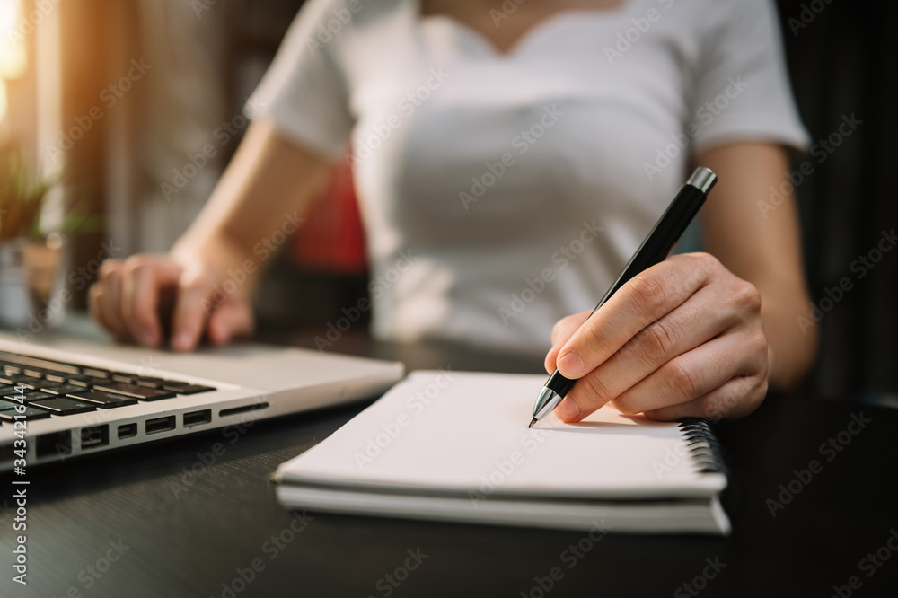 businesswoman hand working with new modern computer and writing on the notepad strategy diagram as c