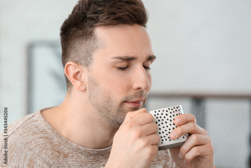 Young man drinking coffee in cafe