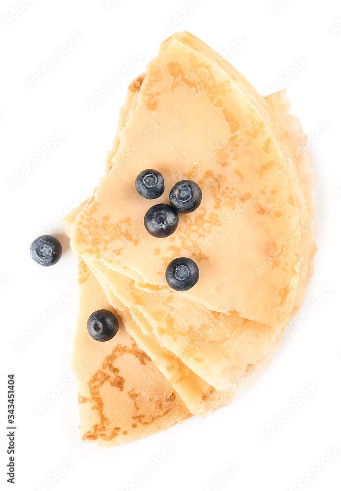 Tasty blini with berries on white background