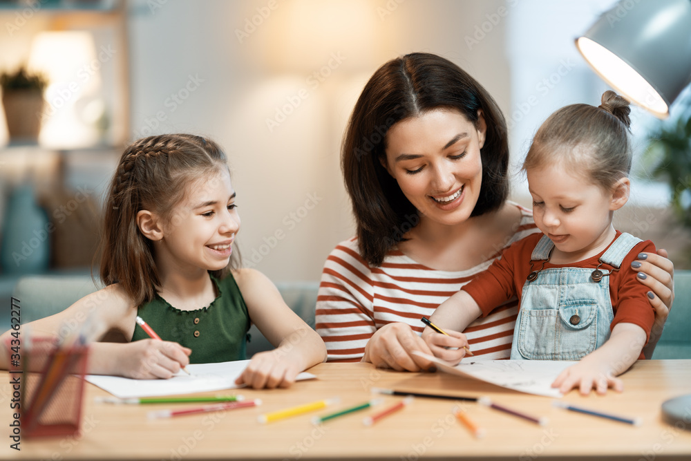 Mother and daughters are drawing together