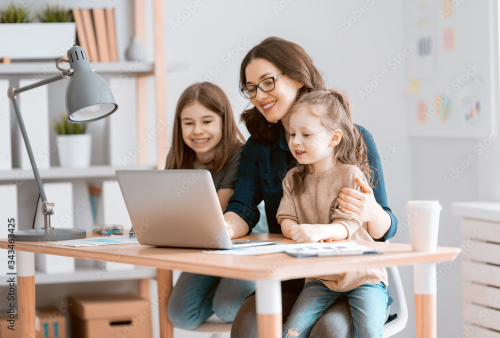 Woman working on a laptop.