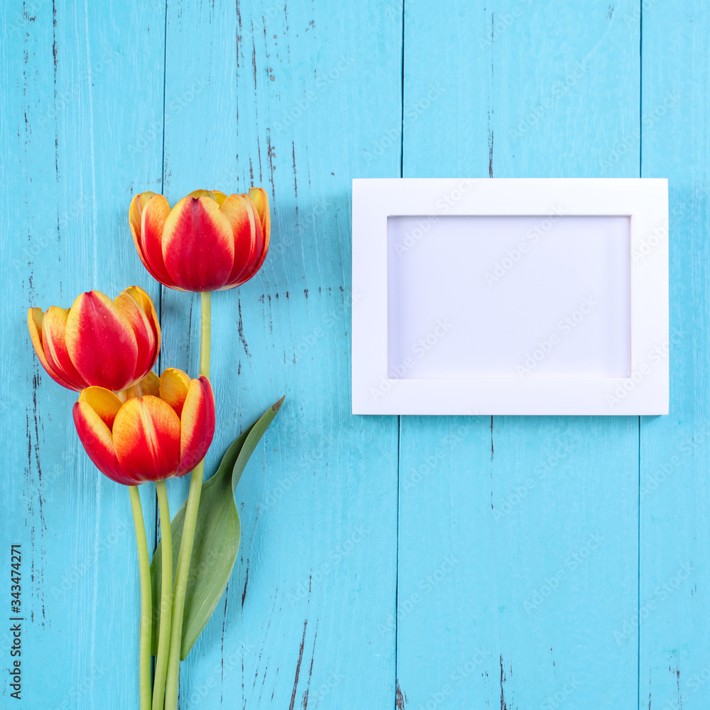 Mothers Day background, tulip flower bunch - Beautiful Red, yellow bouquet isolated on blue wooden 