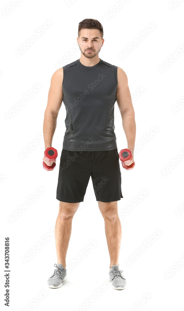 Sporty young man training with dumbbells on white background