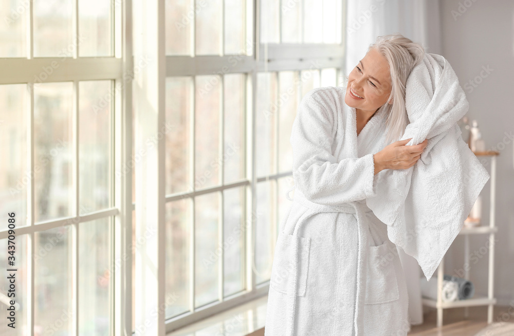 Morning of mature woman in bathroom