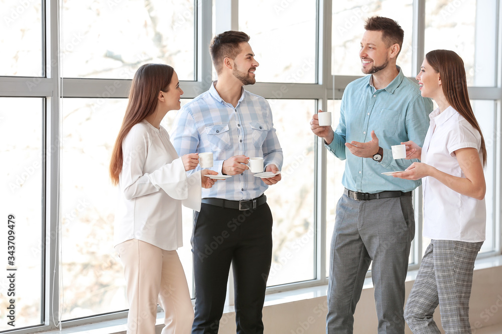 Colleagues drinking coffee in office