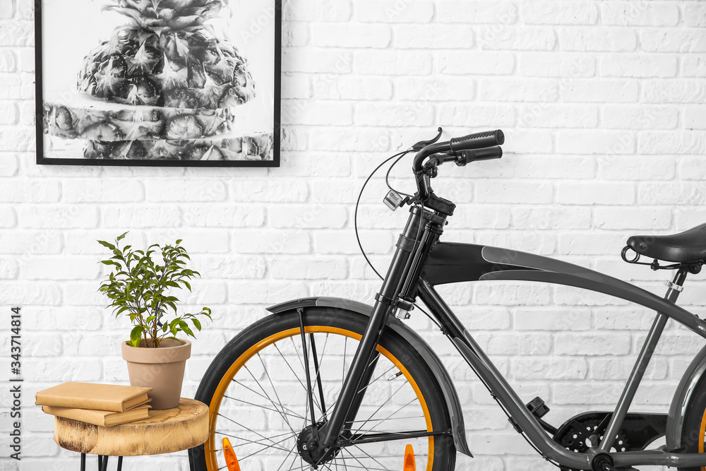 Interior of modern room with table and bicycle