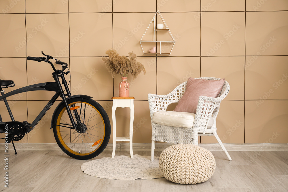 Interior of modern living room with comfortable armchair and bicycle