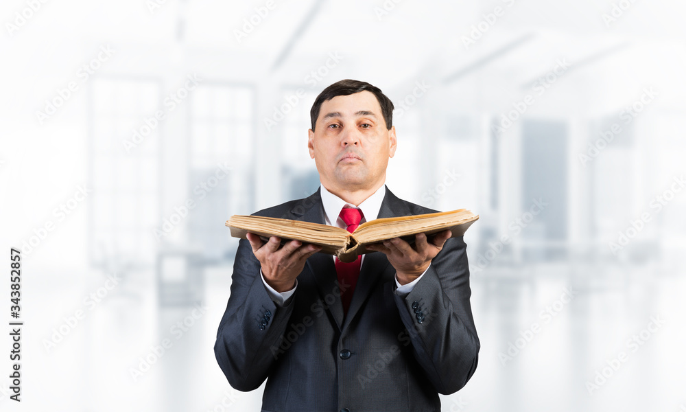 Serious businessman with open book