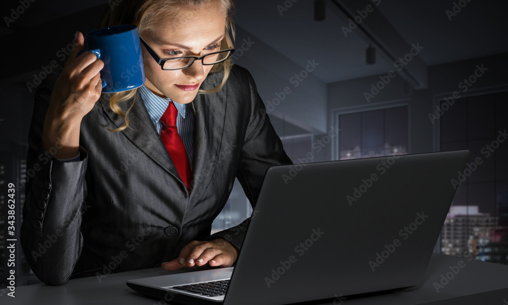 Businesswoman at desk looking at laptop