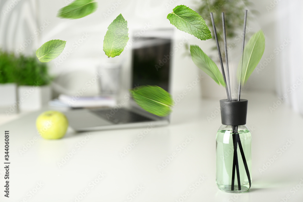 Mint reed diffuser on table in room