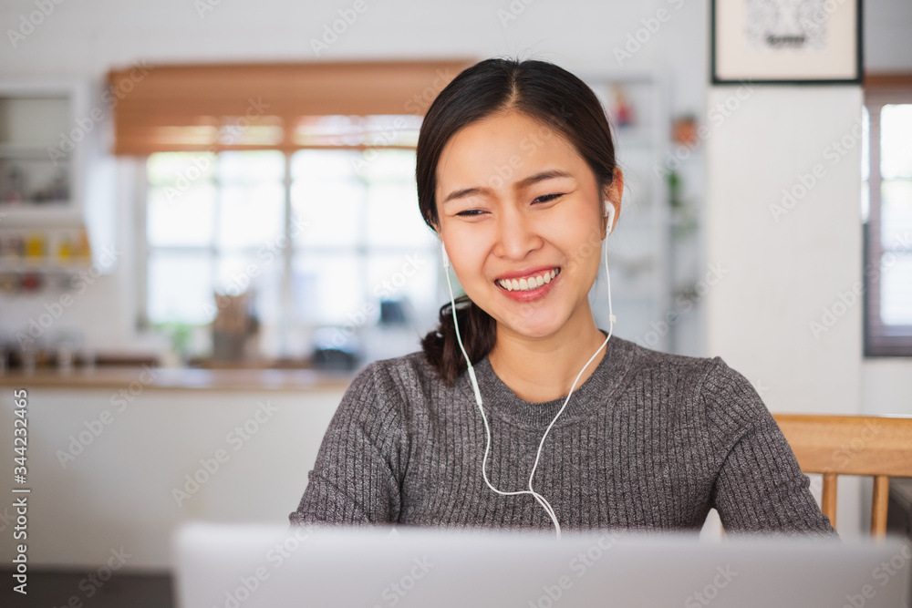 Young Asian businesswoman work at home and virtual video conference meeting with colleagues business