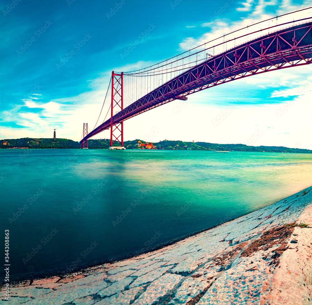 Places of interest in Lisbon, Portugal. Bridge of April 25 and sunset.Portuguese architecture and la