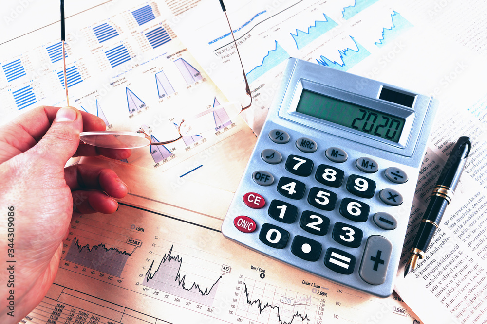 Banking and finance background.Finance and business concept.Pen,calculator over graphs and charts.