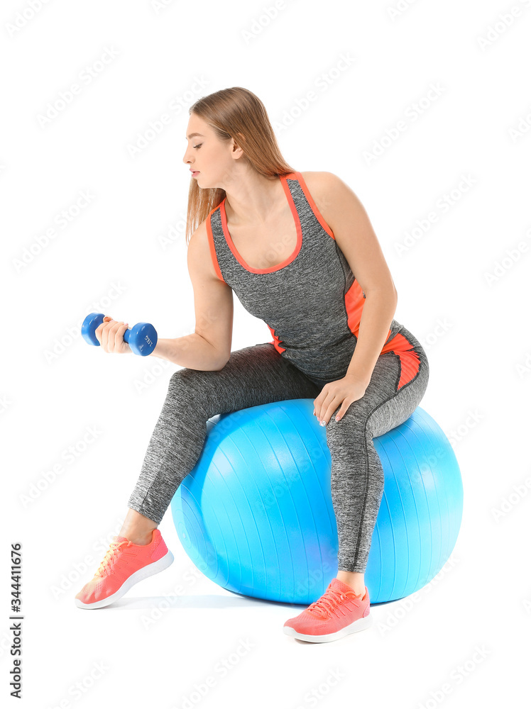 Sporty young woman training with dumbbells on white background