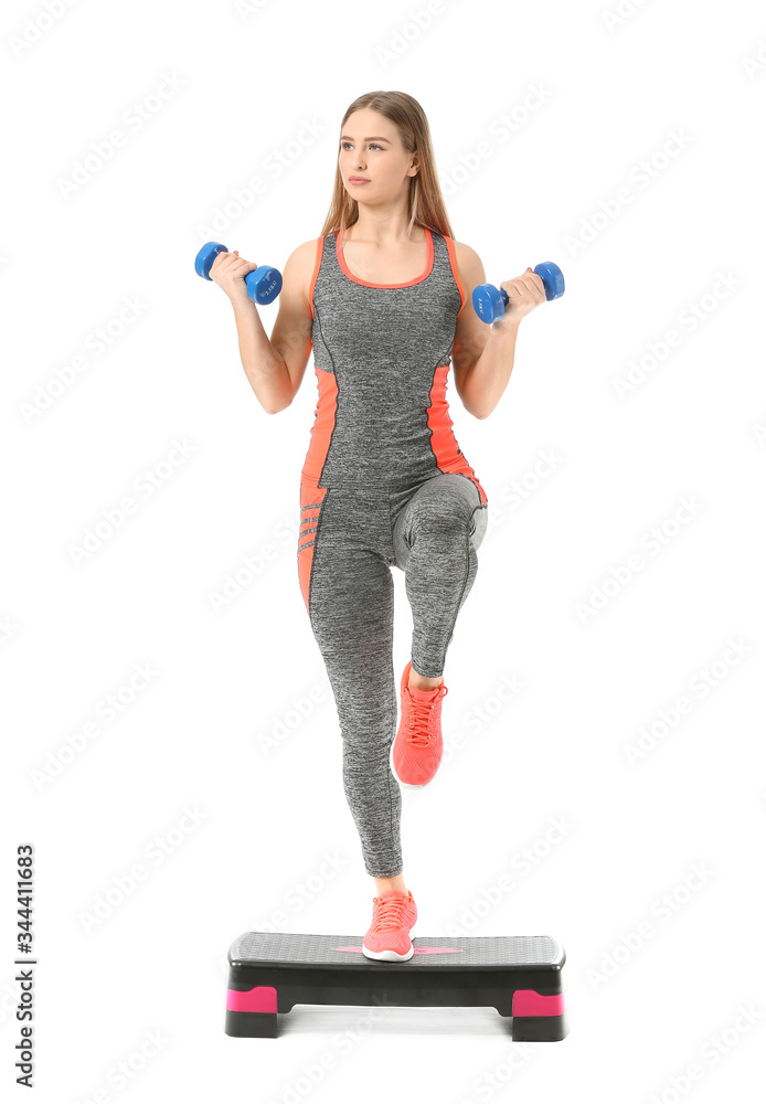 Sporty young woman training with dumbbells on white background