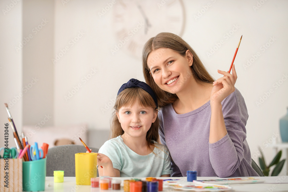 Drawing teacher giving private art lessons to little girl at home