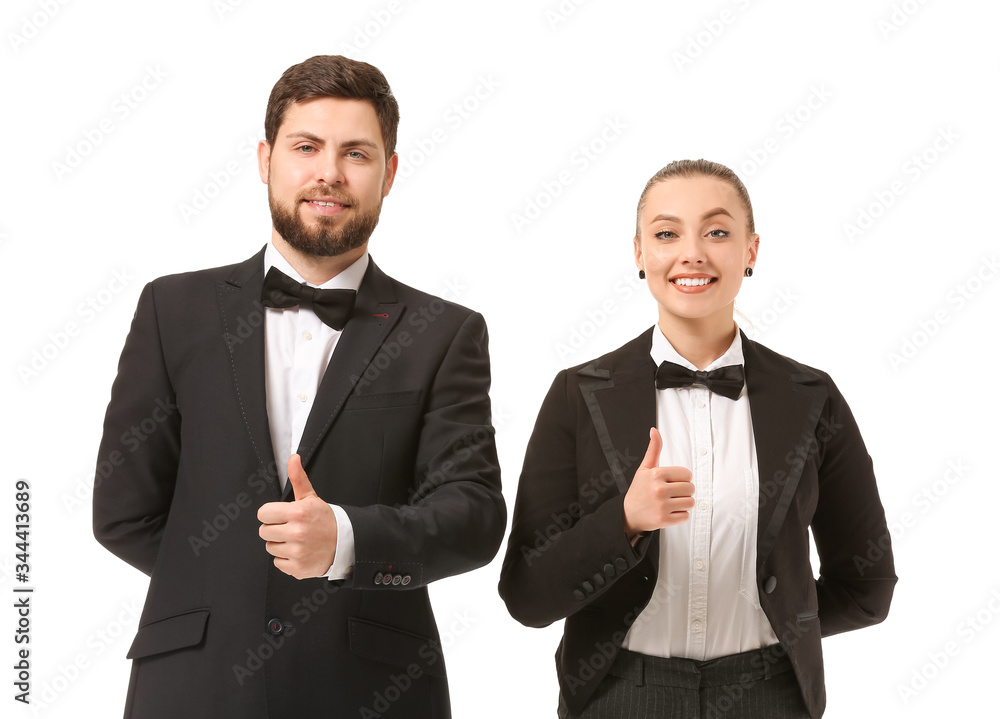 Male and female waiters showing thumb-up on white background