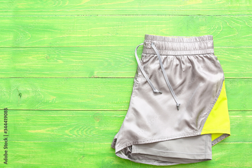 Sportswear on color wooden background