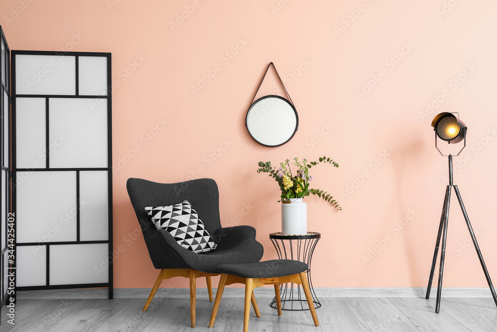 Stylish interior of living room with armchair and mirror