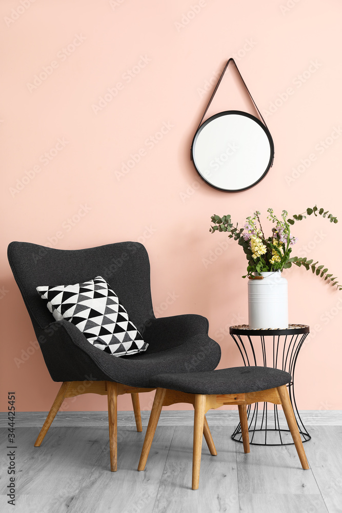 Stylish interior of living room with armchair and mirror