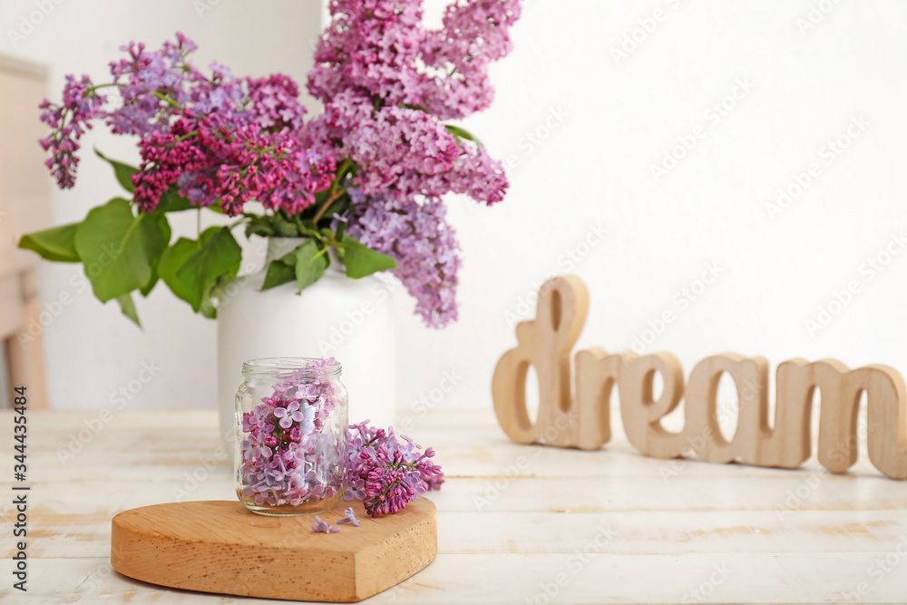 Beautiful lilac flowers on table