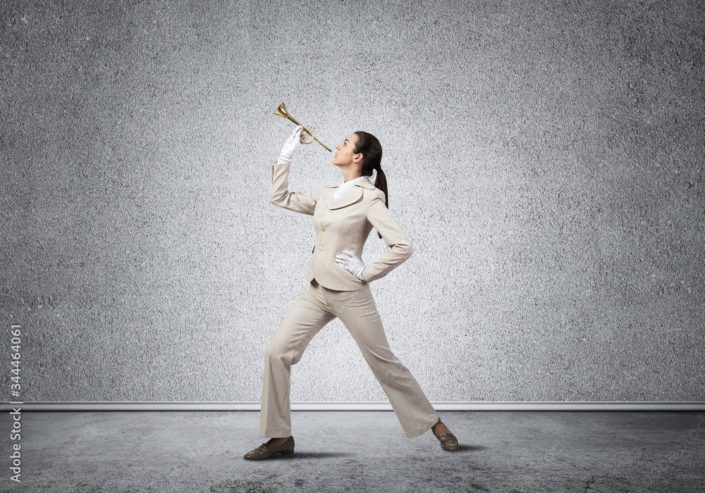 Woman playing trumpet brass instrument