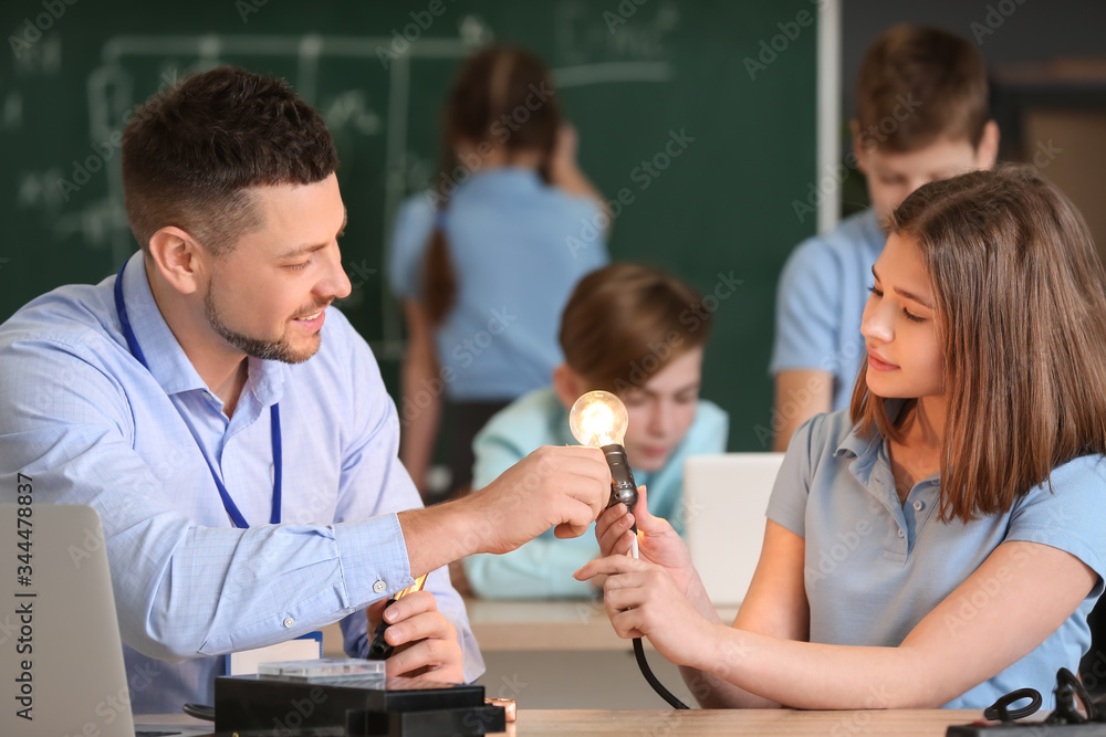 Teacher conducting physics lesson in classroom