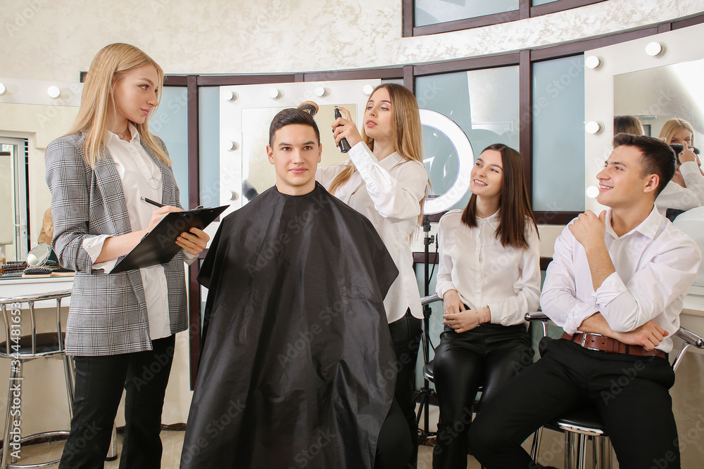 Young people with professional hairdresser and model during courses in salon