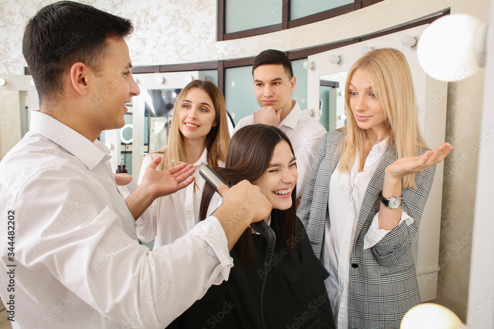 Young people with professional hairdresser and model during courses in salon