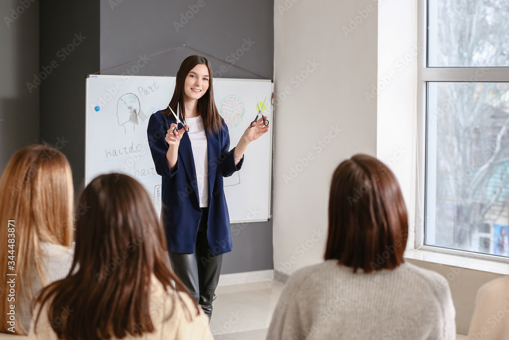 Professional hairdresser teaching young people in office